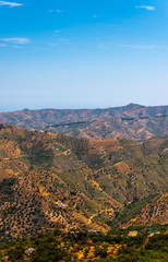 Fototapeta premium beautiful view of the mountains in the region of Andalusia, houses and farmland on the slopes of mountains