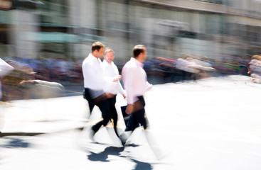 Walking people motion blur. City of London busy business life. People crossing the road 