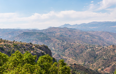 Fototapeta premium beautiful view of the mountains in the region of Andalusia, houses and farmland on the slopes of mountains