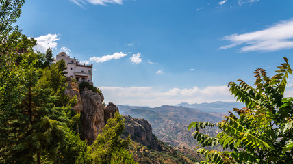 beautiful view of the mountains in the region of Andalusia, houses and farmland on the slopes of mountains