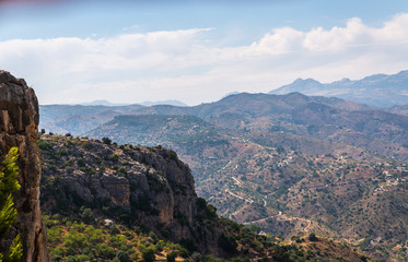 Obraz premium beautiful view of the mountains in the region of Andalusia, houses and farmland on the slopes of mountains