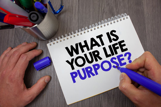 Text sign showing What Is Your Life Purpose Question. Conceptual photo Personal Determination Aims Achieve Goal Man hold holding blue marker notebook page markers table messages ideas.