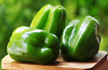 Green peppers isolated on green background