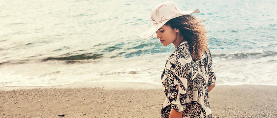 Beautiful woman portrait being pensive on the beach, letterbox