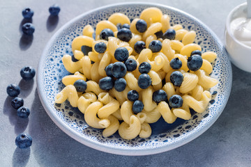 Pasta with blueberries and sour cream.