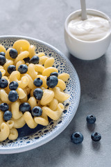 Pasta with blueberries and sour cream.