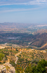 Obraz premium beautiful view of the mountains in the region of Andalusia, houses and farmland on the slopes of mountains