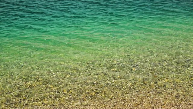 Slow motion of waves on clear water lake