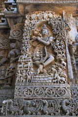 Sculpture of lord Krishna as Muralidhar playing flute , west side wall, Hoysaleshwara temple, Halebidu, Karnataka.
