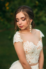 Naklejka premium Girl in wedding dress. Beautiful girl in garden