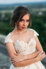 Fototapeta na wymiar Teenage girl in wedding dress on city. Background town sunset
