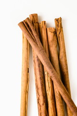 Stack of cinnamon sticks on white background and space