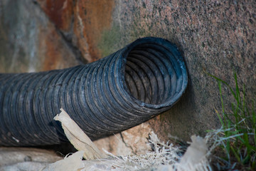 Fototapeta premium Black used corrugated plastic hose is close