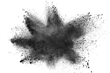 Black powder explosion against white background.Closeup of black dust particles explode isolated on...