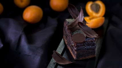 Homemade healthy gluten free cake with apricots on black background