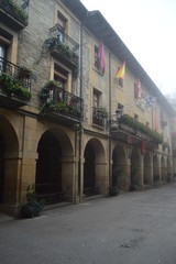 Obraz premium Arched Portals Of The City Hall On A Very Cloudy Day In Laguardia. Architecture, Art, History, Travel. December 26, 2015. La Guardia, Alava, Basque Country, Spain.