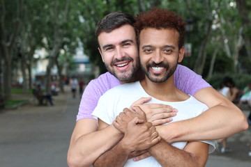 Gay couple holding each other outdoors