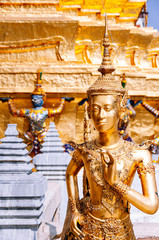 Fototapeta premium Golden angel statue at Emerald Buddha temple or Wat Phra Keaw, Bangkok grand palace