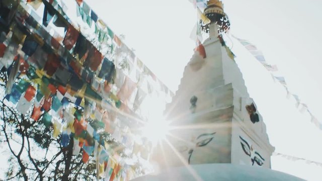 Prayer flags lungta at Stupa in sunrise lights.