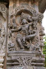 Fototapeta na wymiar Sculptures of dancing Shiva, North East wall, Kedareshwara Temple, Halebid, Karnataka