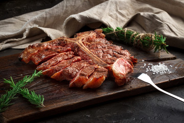 porterhouse steak grilled sliced on a piece of wood Board