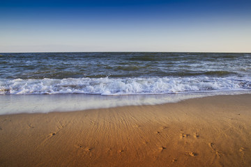 Fototapeta na wymiar beautiful yellow sandy beach near the blue sea