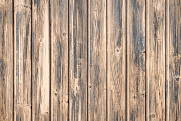 Brown wooden boards of oak color. Vintage old fence or wall of house. Fittings of screws. Background abstract pattern.