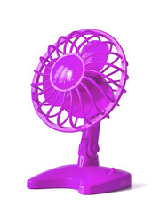 Pink fan on batteries with propeller and protective grille, made of plastic. Isolated on white background