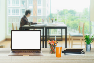 Mock up : Workspace with blank white desktop computer, pencils and stationery items. Blank screen for graphics display montage.