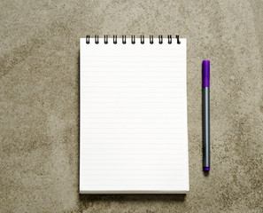 notebook and pen on a marble background