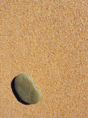 Single stone on Sand Background