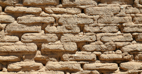 Handmade mud-brick wall creating a pattern
