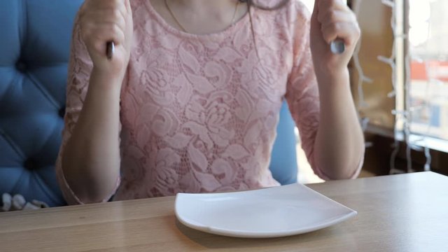 brunette woman requires an order in a cafe that waits a long time.