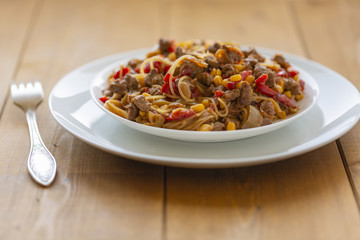 Noodles with meat and vegetables  in sweet and sour sauce.