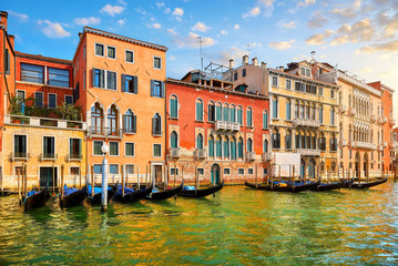 Fototapeta na wymiar Venice, Italy. Gondolas with floating at piers by Grand Canal