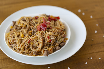 Noodles with meat and vegetables  in sweet and sour sauce.