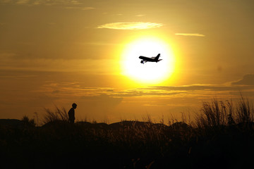 Fototapeta na wymiar Sunset and Plane
