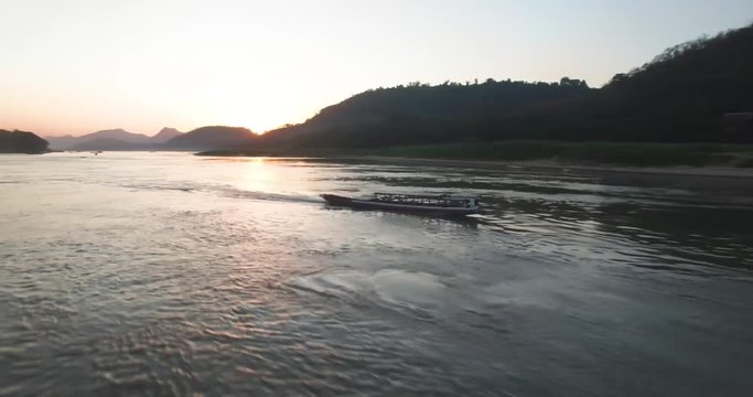 Small speed boat traveling up Loas River