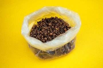 cloves, folded in a bag on a yellow background
