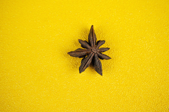 anise on yellow background