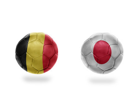 football balls with national flags of belgium and japan.