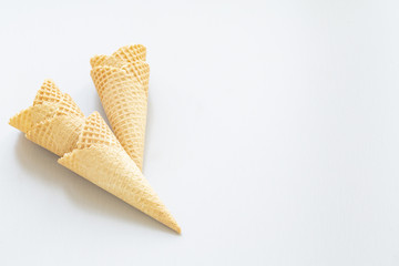 Waffle ice cream cone on a light background, with space for text.