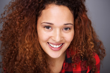 Close up smiling mixed race girl with curly hair