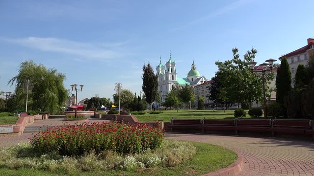 Public park at the Soviet square with the St. Francis Xavier Cathedral at background.  Grodno, Belarus