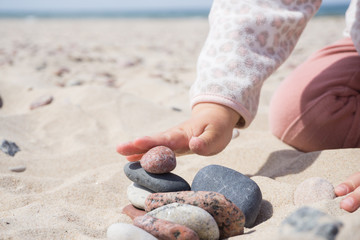 Tower of stones on the coast of Baltic Sea in summer sunny day