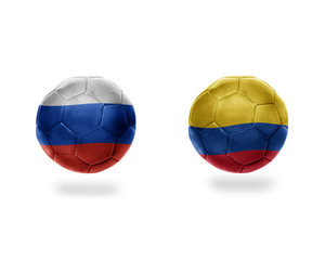 Fototapeta premium football balls with national flags of colombia and russia.
