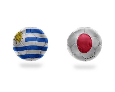 football balls with national flags of japan and uruguay.