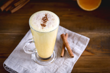 Pumpkin Latte with Spices Anise Cinnamon Sticks Tasty Latte with Whipped Cream Wooden background Above