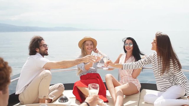 Group of Caucasian high school students participating in sea excursion to picturesque islands. Business or educational travelling on yacht. Cruise vacation.