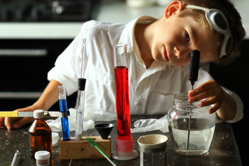 Young serious scientist chemist making  scientific experiments. Kids in STEM
